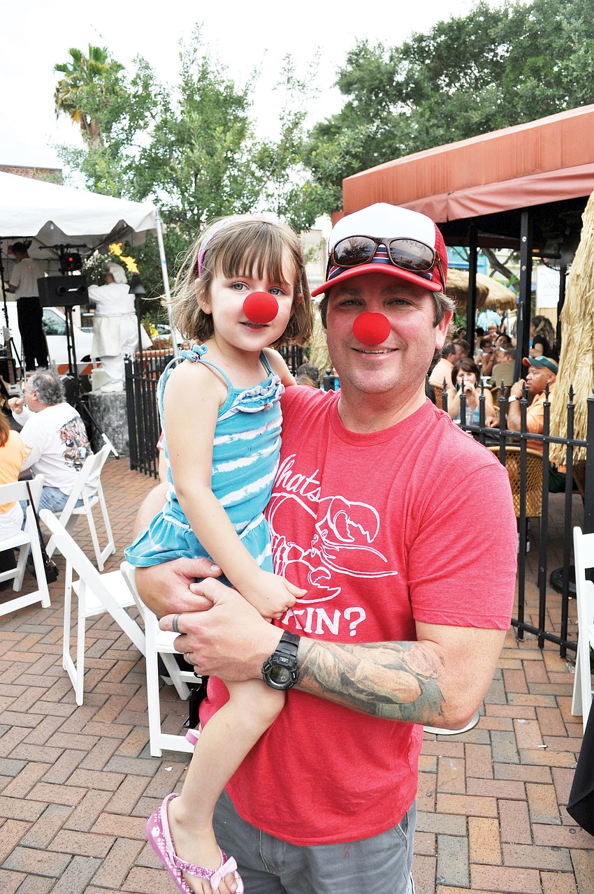 Todd Tedder and his daughter, Sophia, wore clown noses to the downtown block party that was held at Mattison's City Grille to watch local circus performer Nik Wallenda's daring tightrope walk over Niagara Falls.