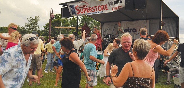 People have fun dancing around on the grass during Friday Fest at Van Wezel.