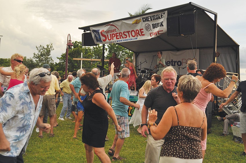 People have fun dancing around on the grass during Friday Fest at Van Wezel.