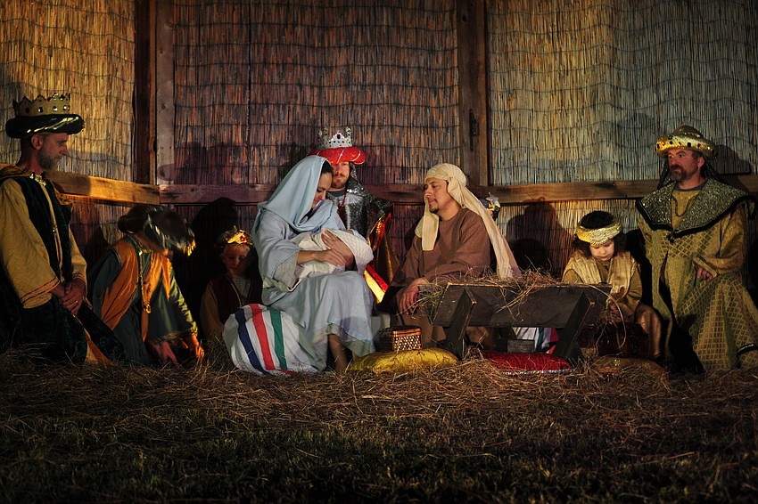 Mary and Joseph and the baby Jesus, portrayed by Whitney Kitchens, Carlos Motta and Hudson Drake.