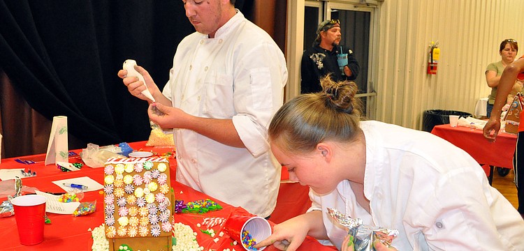 Grant Barrett, 16 and Sierra Civin, 17, both of Port Charlotte High School, work together during the Iron Chef competition. Their teacher Chef Ron Westrom gave them bakerâ€™s shirts to wear to look more professional at the competition.