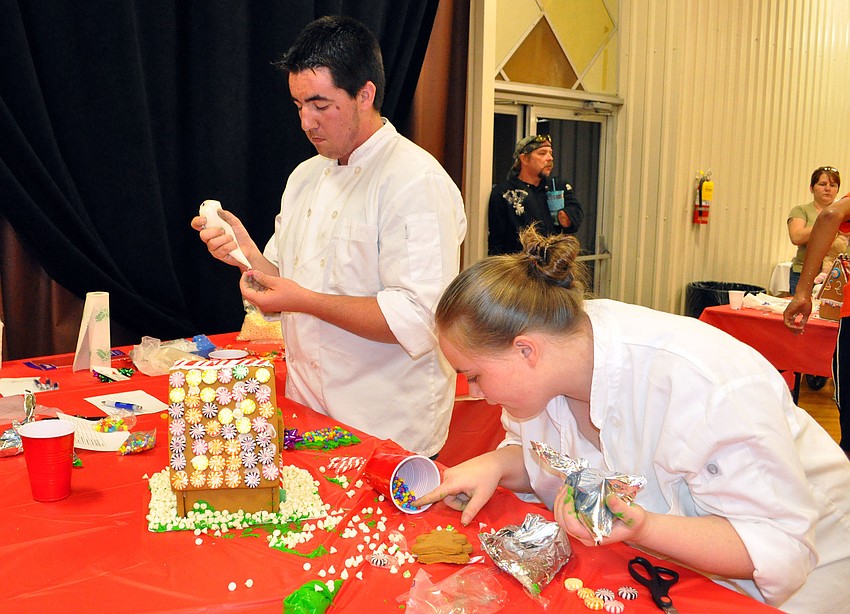 Grant Barrett, 16 and Sierra Civin, 17, both of Port Charlotte High School, work together during the Iron Chef competition. Their teacher Chef Ron Westrom gave them bakerâ€™s shirts to wear to look more professional at the competition.