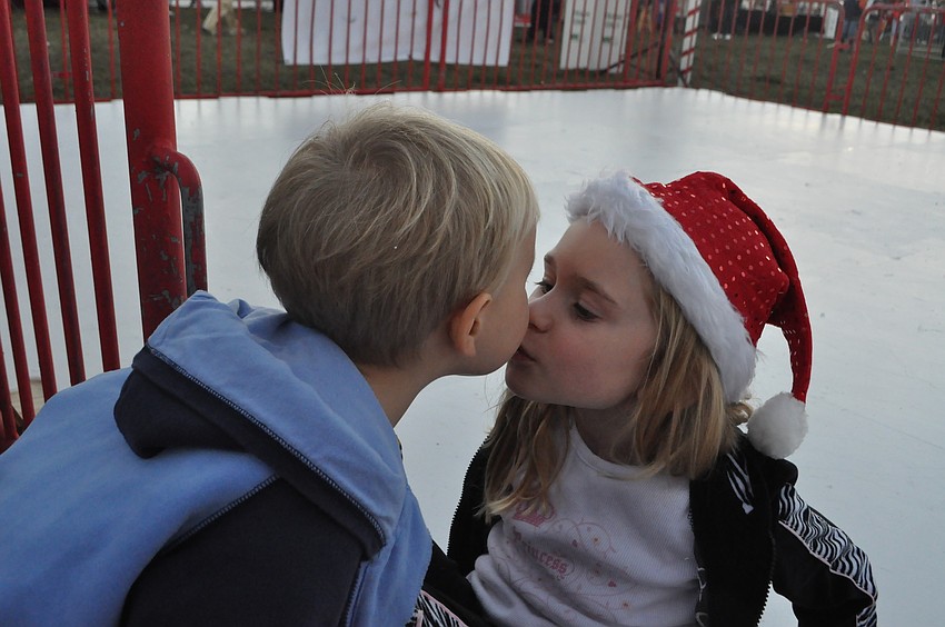 Jensen Dieckman, 2, gives his sister EsmÃ©e, 6, a kiss at the ice skating rink.
