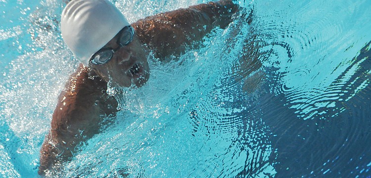 John Krueger competes in the 100 breaststroke in the FHSAA Class 1A Region 3 Swimming and Diving Championships at the Selby Aquatic Center.