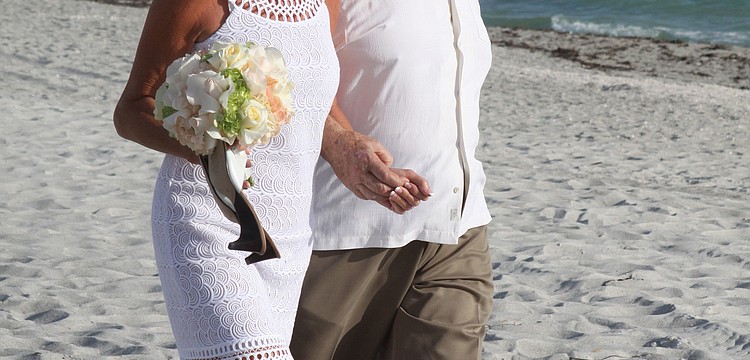 Adm. Steve Branham married Susan Phillips July 28 in a beach ceremony on Longboat Key.