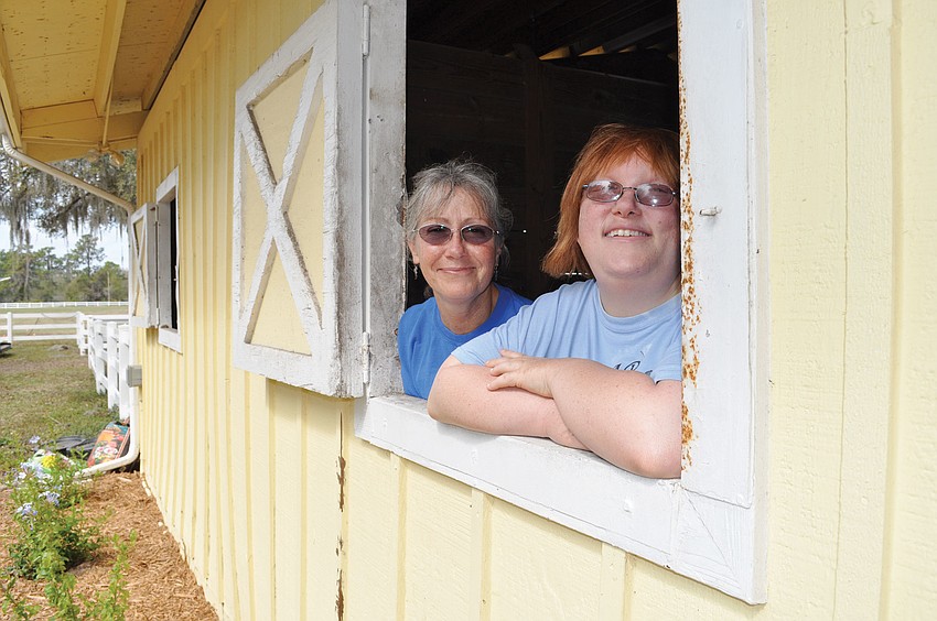 SMART Volunteer Executive Director Gail Clifton and SMART rider Jessica Stort were eager to show off one of the new barns. SMART moved to its new 23-acre home March 1. Published March 1, 2012.