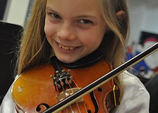 Chelsea Ball practices the violin right before the concert.