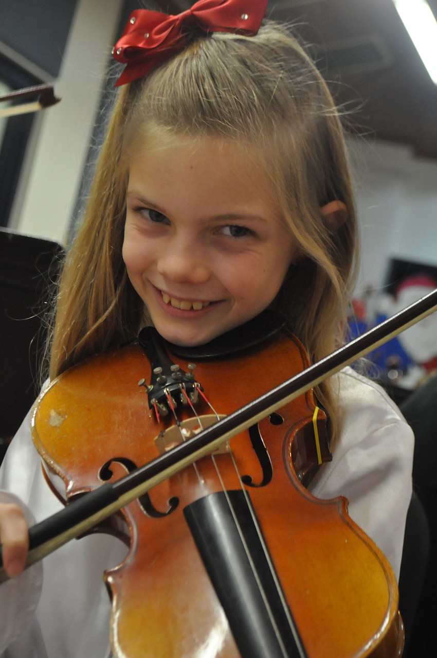 Chelsea Ball practices the violin right before the concert.