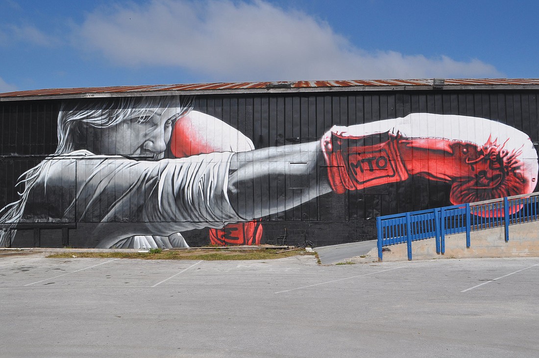 MTO's newest mural, painted on the wall of Sarasota Fight and Fitness Club, depicts Sarasota Chalk Festival founder Denise Kowal as a boxer.