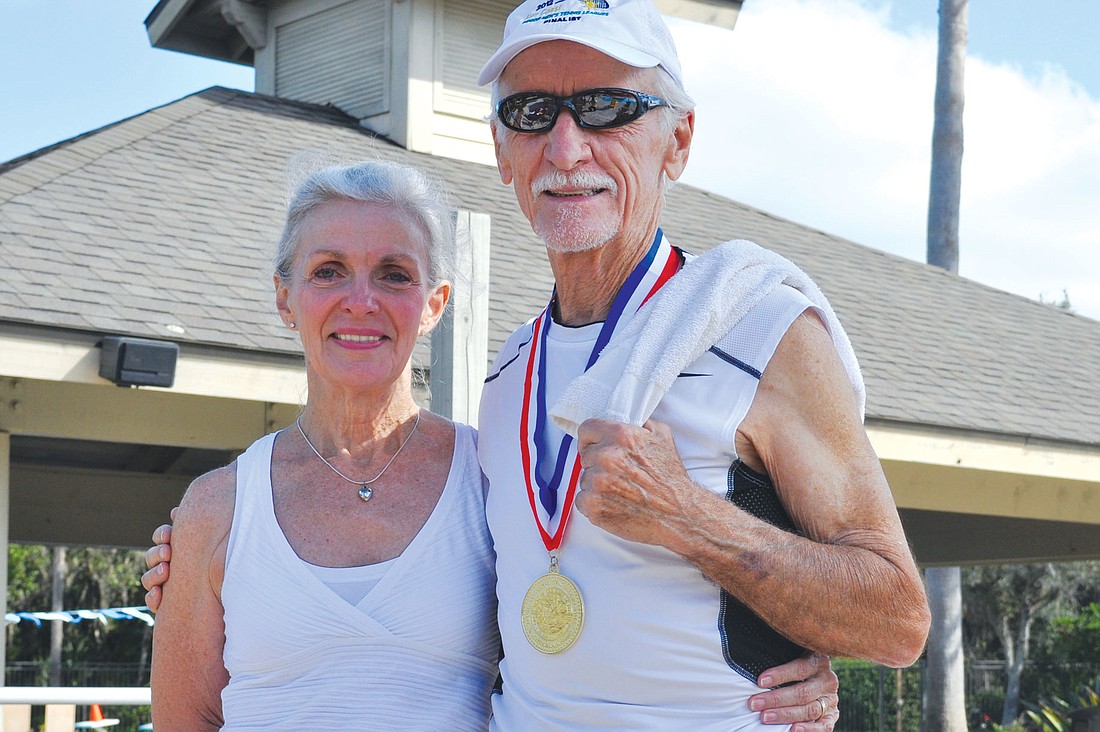 Jerry Pujol with his wife, Carolyn, who taught him how to run. Pujol also showed off his gold medal from the Senior Games State Championships.