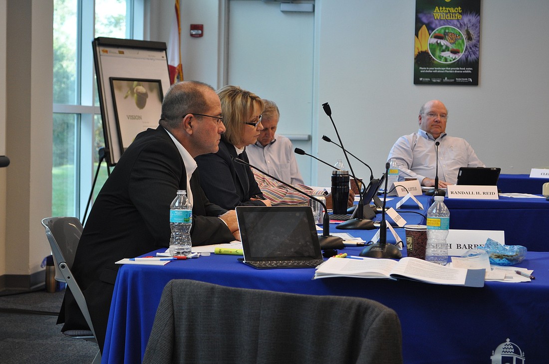 Assistant Sarasota County Administrators Tom Harmer, Lee Ann Lowery, and Mark Cunningham, and County Administrator Randall Reid confer with commissioners during a Dec. 7 retreat.