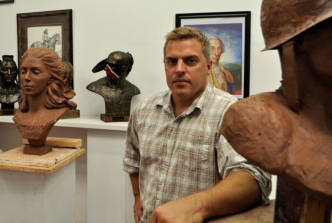 Greg Marra poses with several of his historical sculptures in his studio, off Ashton Road, where he teaches students the basics of sculpting.