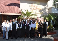 The staff of CafÃ© Lâ€™Europe gathers for a group picture before guests arrive to celebrate the restaurantâ€™s 40th anniversary.