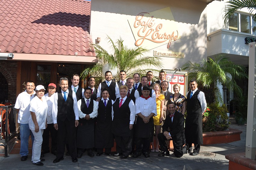 The staff of CafÃ© Lâ€™Europe gathers for a group picture before guests arrive to celebrate the restaurantâ€™s 40th anniversary.