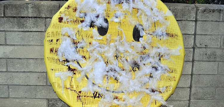 The smiley face after being tarred and feathered by members of The Anti-SRQ Walmart Direct Action Planning Committee.