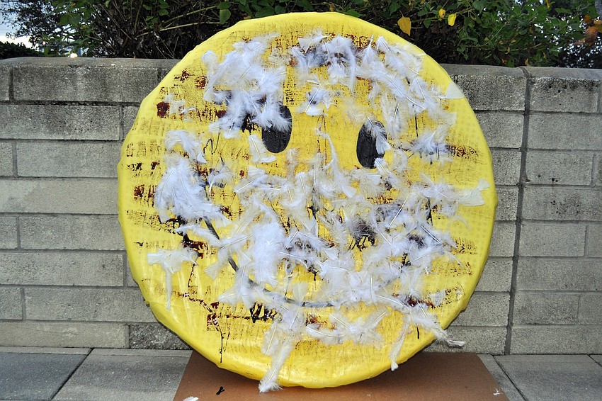 The smiley face after being tarred and feathered by members of The Anti-SRQ Walmart Direct Action Planning Committee.