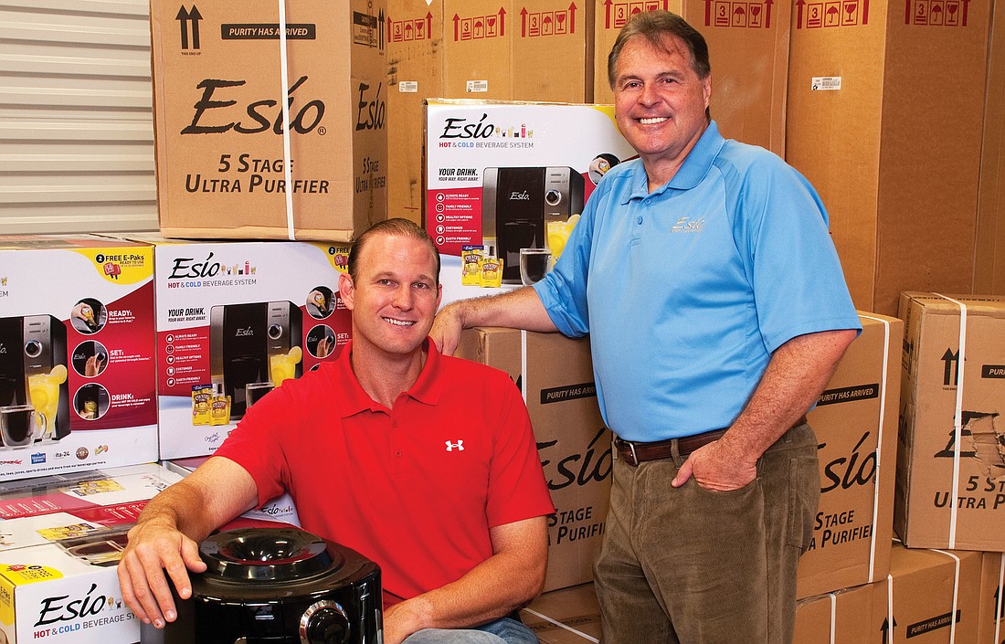 Matt Drews, sitting, and Chuck Vollmer run the Sarasota-based franchise for Esio Beverage System. The company offers what it calls the first hot-and-cold, ready-to-drink beverage dispenser on the market. Photo by Lori Sax.