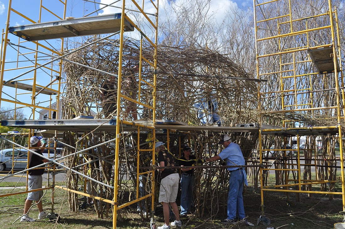 Volunteers are busy on day three of the Patrick Dougherty installation