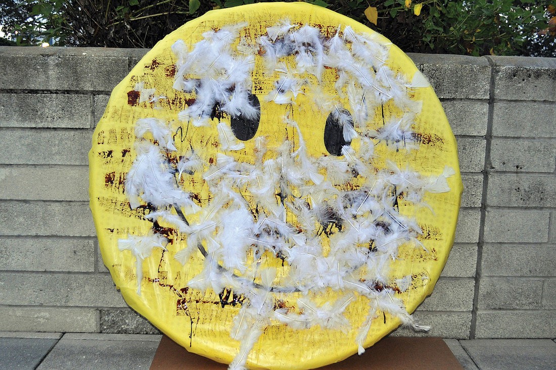The Anti-SRQ Walmart Direct Action Planning Committee tarred and feathered a Wal-Mart smiley face prior to the meeting at City Hall. Photos by Rachel S. O'Hara.