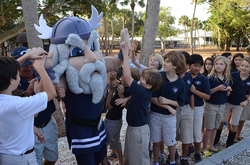 Kids get excited as mascot Thor makes his way to the ribbon cutting.