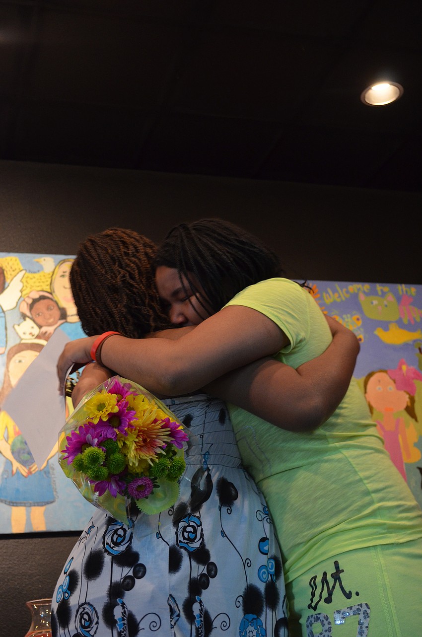 Zandy Sanders gives her mother Shakeyla Dozier a hug during the announcement.