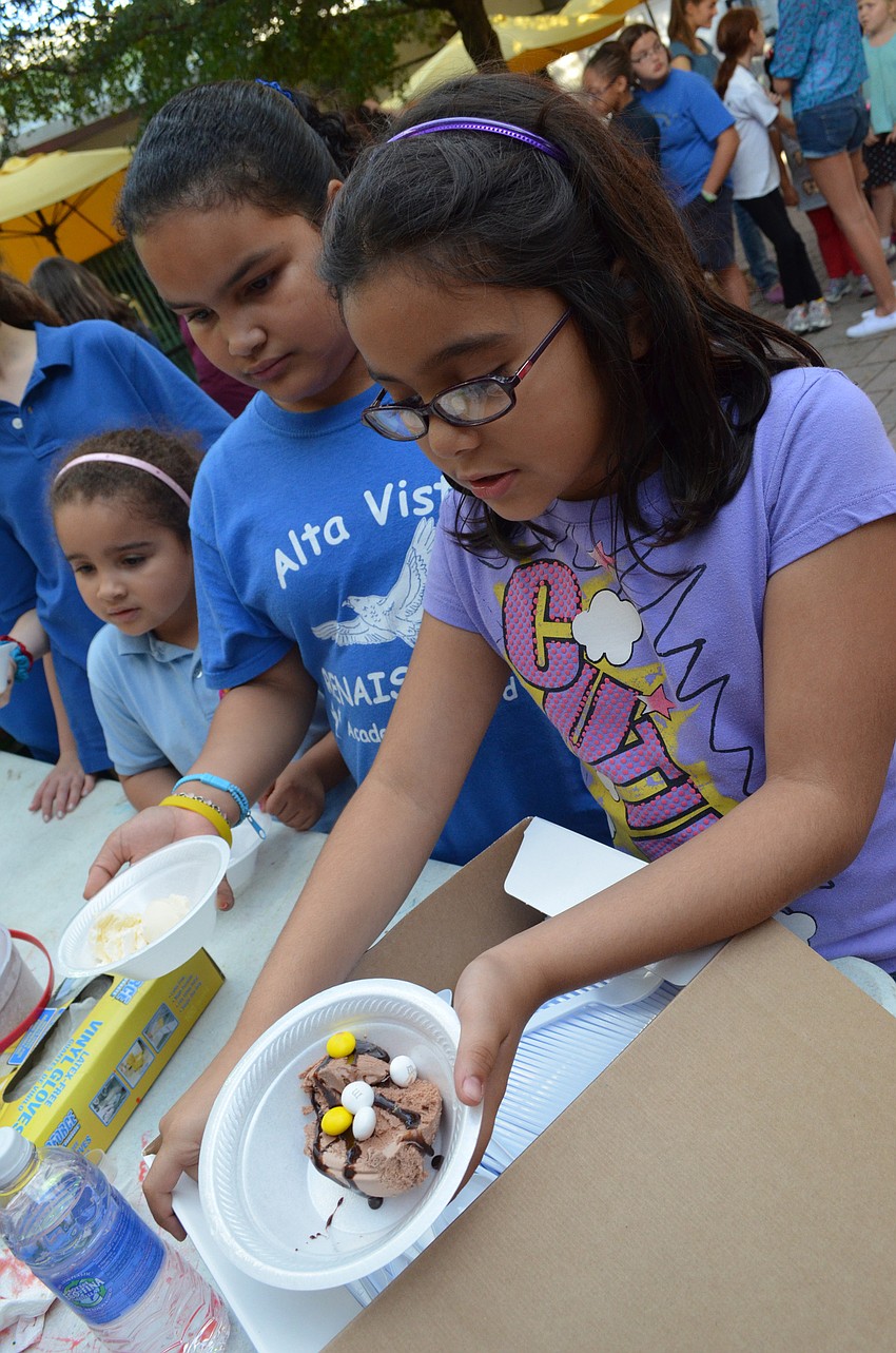 Dana Jinete, Rheann Stephens and Onyx Whack get ice cream with their choice of toppings after the surprise announcement.