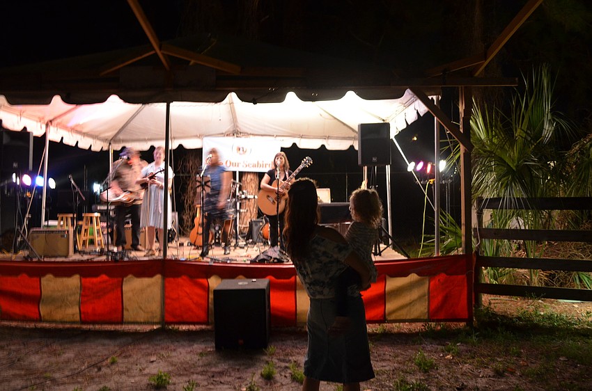 Passerine, which means songbird, performs as Lisamichelle Lemurian sways to the music with her daughter Trinity.