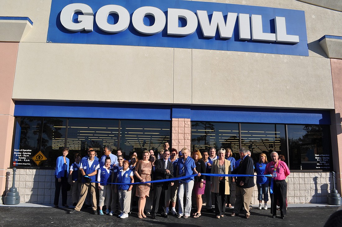 Before the ribbon cutting, a handful of customers waited outside for the new Goodwill to open. Photo by Nick Friedman.