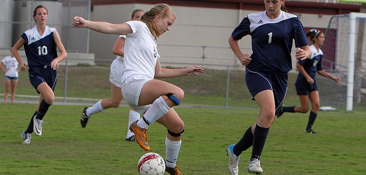 Riverviewâ€™s Rachel Easterling, No. 5, tries to keep the ball away from North Portâ€™s Kelley Mayo, No. 1.