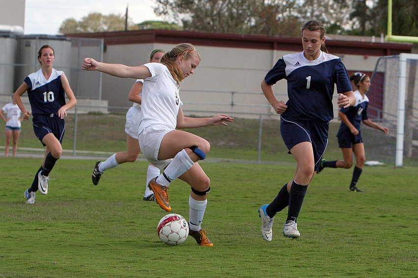 Riverviewâ€™s Rachel Easterling, No. 5, tries to keep the ball away from North Portâ€™s Kelley Mayo, No. 1.