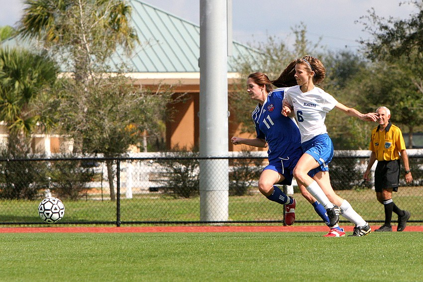 Northside Christianâ€™s Kayla Church, No. 11, and Sarasota Christianâ€™s Danielle Buncik, No. 6, both run for the ball.