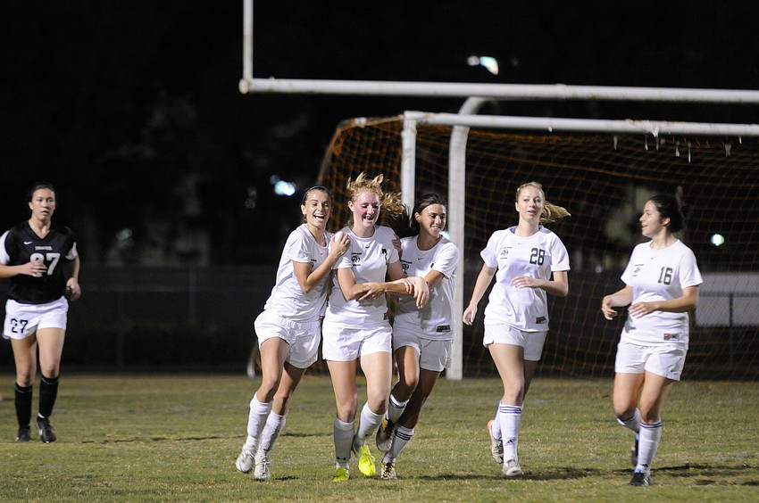Members of the Lakewood Ranch High girls soccer team celebrate following midfielder Talia Falcoâ€™s goal in the second half.