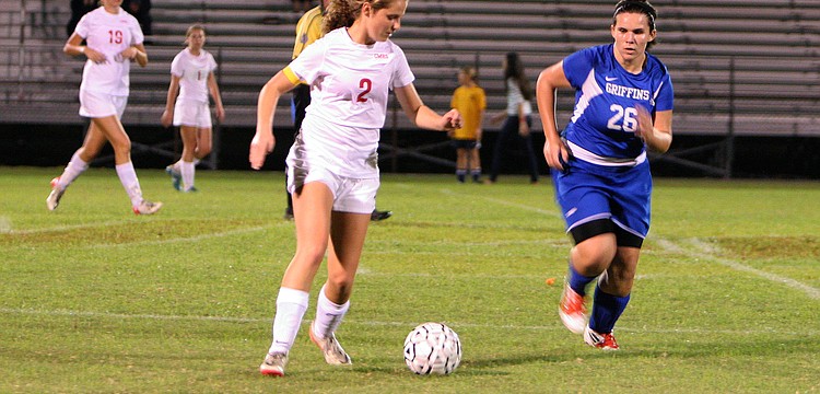 Cardinal Mooneyâ€™s Abby Goecker, No. 2, runs with the ball as Gatewayâ€™s Morgan Brady, No. 26, tries to stop Goecker.