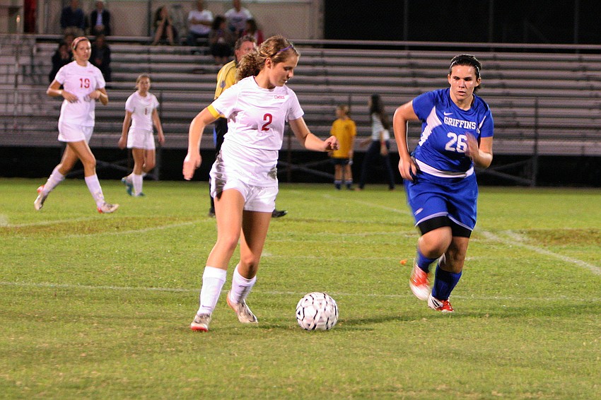 Cardinal Mooneyâ€™s Abby Goecker, No. 2, runs with the ball as Gatewayâ€™s Morgan Brady, No. 26, tries to stop Goecker.