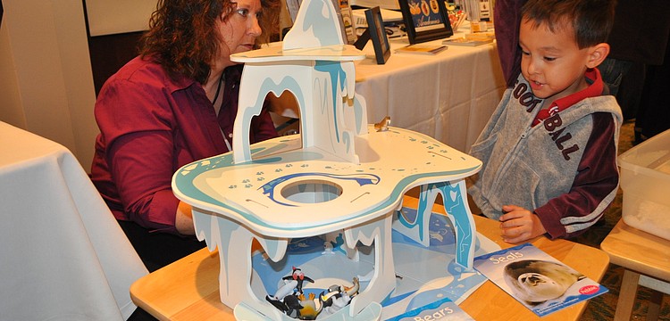 Sindy Jones of Foundations Academies in Sarasota watched Alex Johnson play with the Interactive Polar Playland.