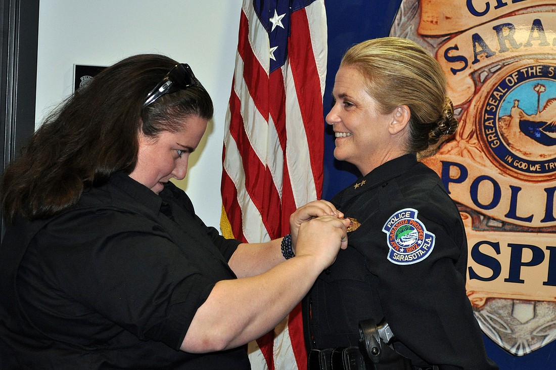 Bernadette DiPino's daughter, Tabitha Hays, a police officer in Maryland, pinned the badge on the chief.