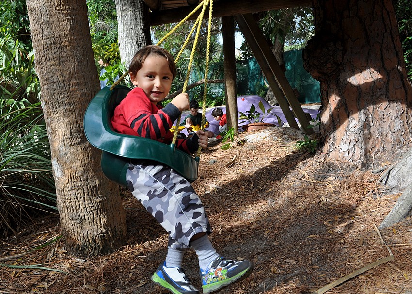Luca Schlosberg rides a swing in the Childrenâ€™s Garden.