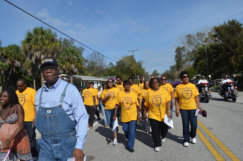 Community members march down Dr. Martin Luther King Way.