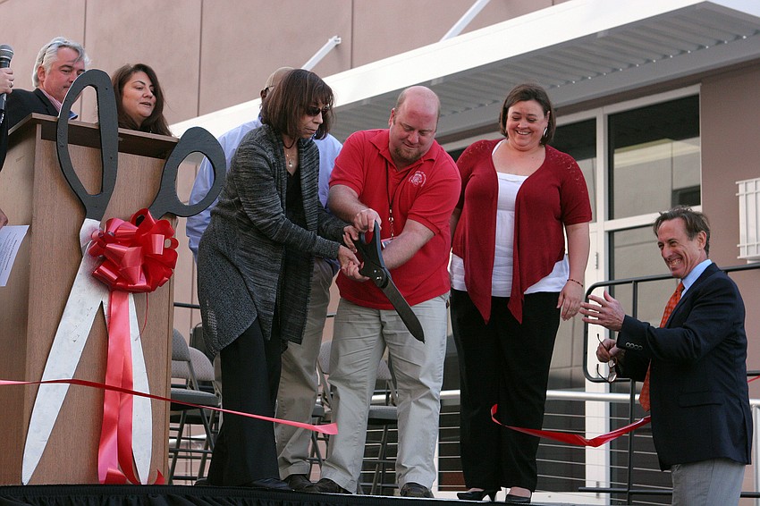 Marilyn Highland, Mickey Stone and Tanya Jones cut the ceremonial ribbon.