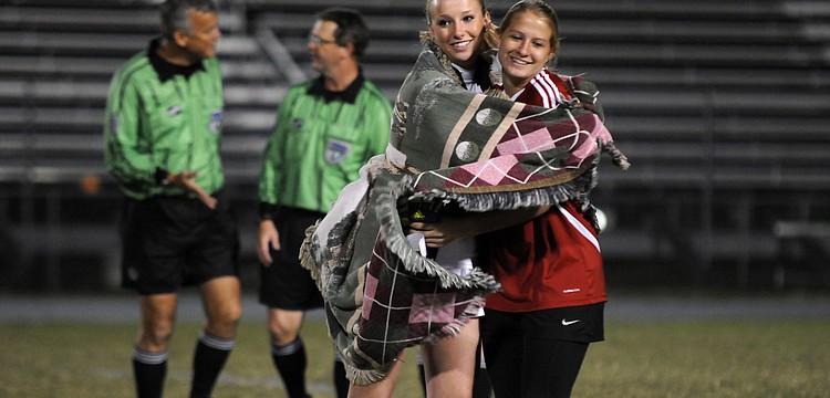 Aubrey Riggins celebrates with goalkeeper Alex Latham following the Lady Mustangs 4-1 regional quarterfinal victory over Cape Coral Ida Baker Jan. 23.