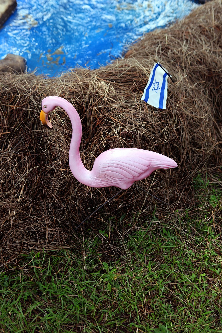 Pink, plastic flamingos and little, Israel flags lined the â€œRiver Jordanâ€.