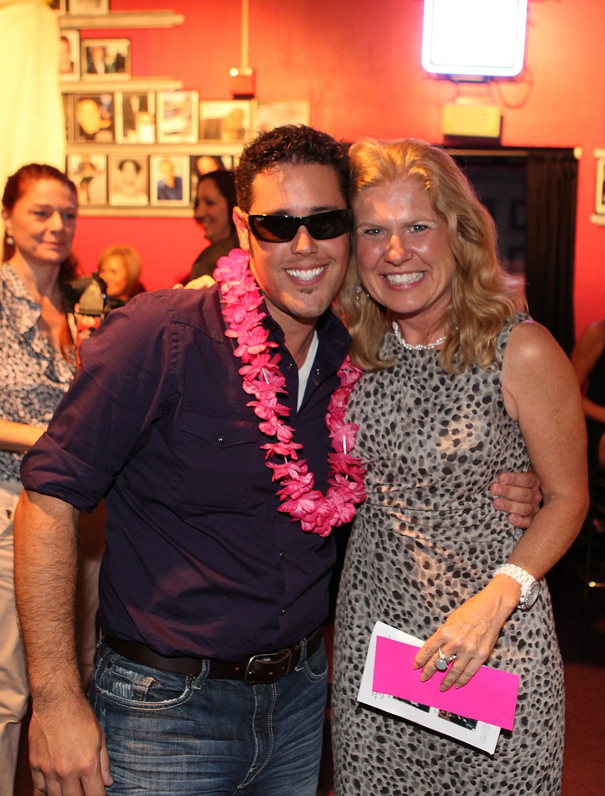 Frank Maggio poses with Mara Hammer-McBee who bought Maggioâ€™s package for $2000.