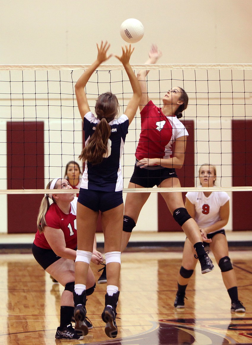 The Out-of-Door Academyâ€™s Gabriella Costa, No. 3, tries to block Cardinal Mooneyâ€™ s Kelly Firek, No. 4, spike over the net Thursday, Sept 20 at Cardinal Mooney.