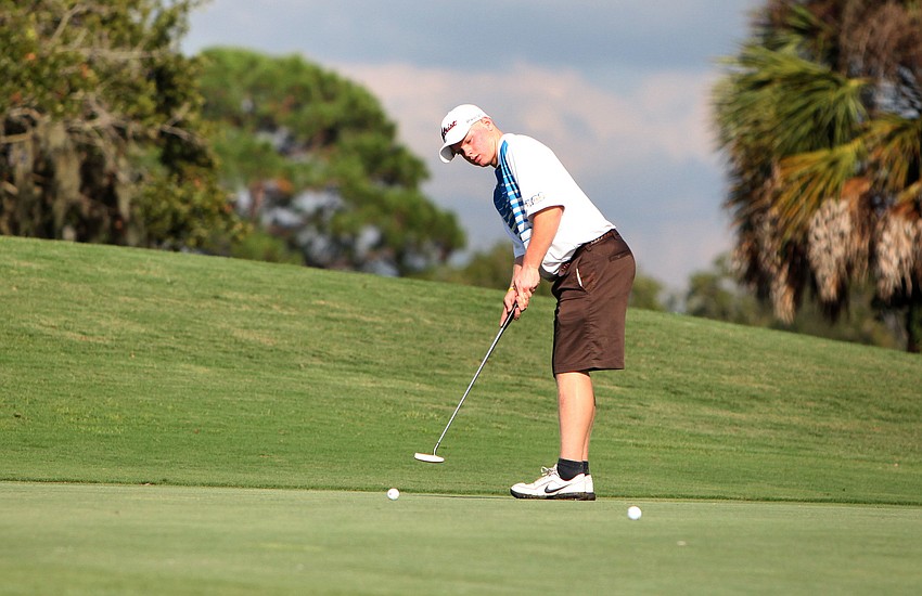Austin Mullenax, 15, of Sarasota Christian, putts his ball in hopes of getting it in the hole Tuesday, Oct. 9, at the Bent Tree Country Club.