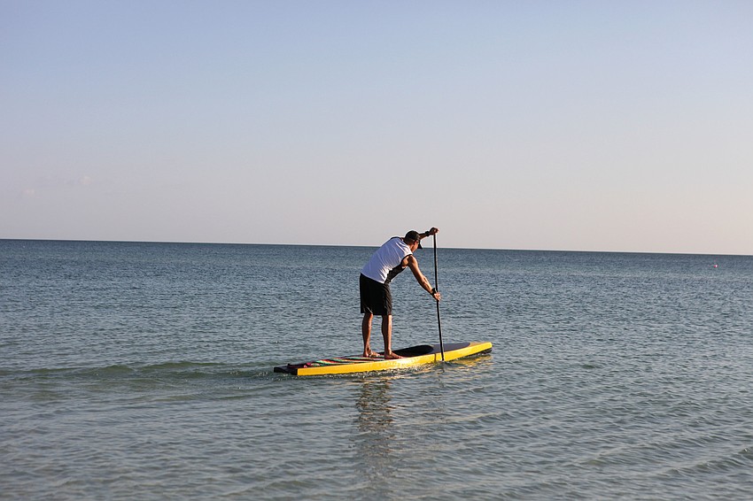 Brad Ward takes the first hour-long shift as he heads out into the Gulf of Mexico for the first hour of the 24-hour paddleboarding event Saturday, Oct. 13, at Siesta Key Public Beach.