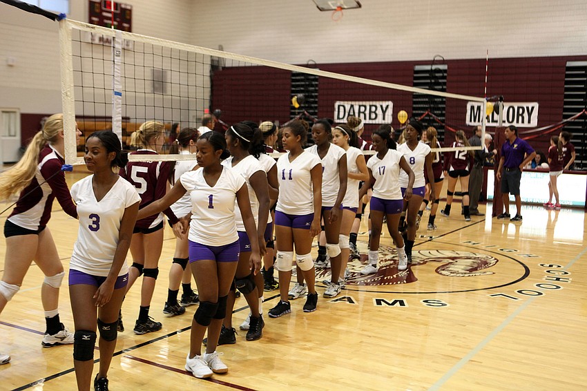Riverview and Booker varsity volleyball players congratulate one another on playing a good game Tuesday, Oct. 16, at Riverview High School. Riverview won the match 3-0.