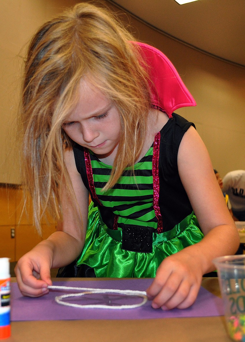 Ella Taylor, 6, dressed up as a pink and green witch