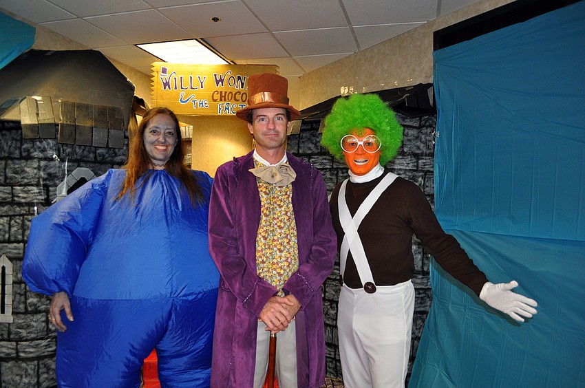 Camille Young, Jay Henderson and Joe Malave of UBS dressed up as characters from Willy Wonka and the Chocolate Factory Wednesday, Oct. 31, inside their office.