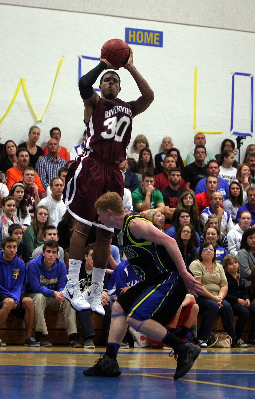 Austin Walker, No. 30, attempts to shoot a three-pointer.