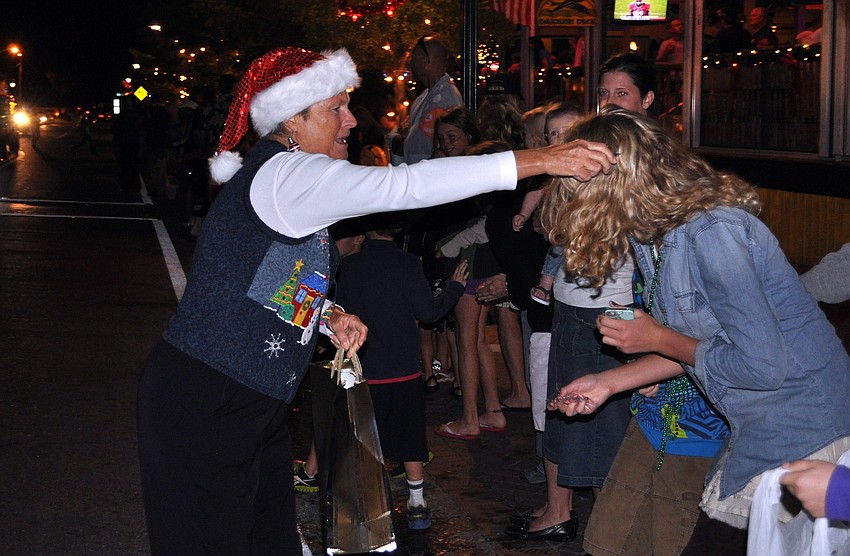 Marti Maxim of The Local Bean passed out candy Saturday, Nov. 24, during Siesta Keyâ€™s Light Up the Village parade.